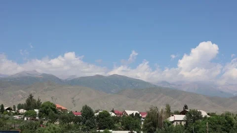 Timelapse of Clouds Moving Over City with Mountains in the Background Stock Footage 344733350