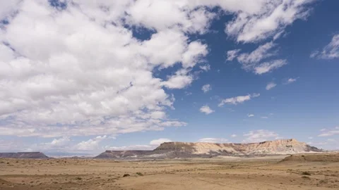 Timelapse of clouds moving over factory butte, usa in 4k Stock Footage 338095263