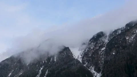 Timelapse Clouds moving over Mountains, Swiss Alps, Snow &amp; Trees, 4k Stock Footage 231250641