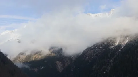 Timelapse Clouds moving over Mountains, Swiss Alps, Snow &amp; Trees, 4k Stock Footage 231250682