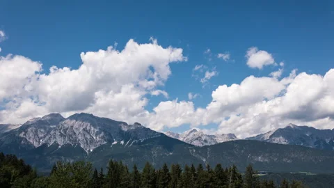 Timelapse of clouds moving over mountains at sun light in austria Stock Footage 249808017