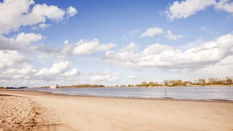Timelapse of clouds moving over a river landscape in spring Stock Footage 127958056