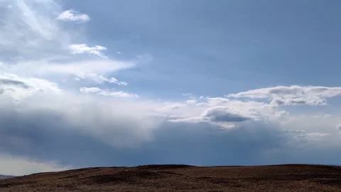 Timelapse clouds moving over rocky hill. Stock Footage 328336962