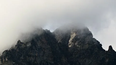 Timelapse of clouds moving over a rocky mountain peak Stock Footage 344418721