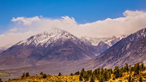 Timelapse - Clouds moving over Snowcapped Mountain Peaks -4K Stock Footage 91569249