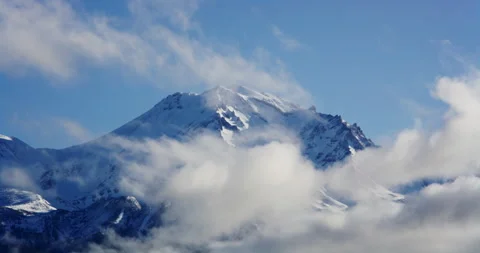 Timelapse of clouds moving over snowy mountain Stock Footage 220938209