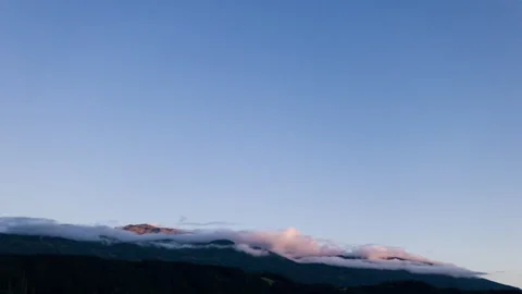 Timelapse of clouds moving over stylized mountain at sunset in austria Stock Footage 249806584