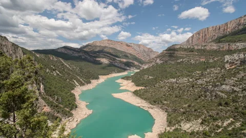 Timelapse of clouds moving over turquoise gorge and green mountains in Spain Stock Footage 221585501