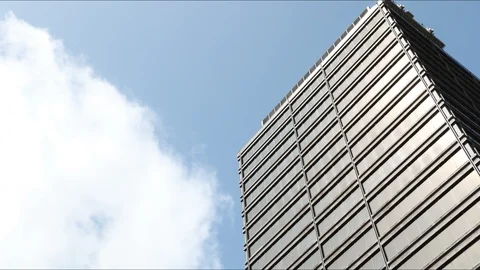 Timelapse clouds moving right to left behind an office building Stock Footage 92966840