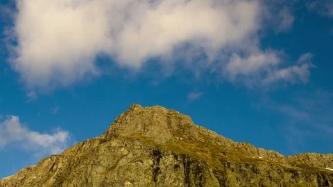 Timelapse of clouds moving slowly over mountain peak Stock Footage 75010030
