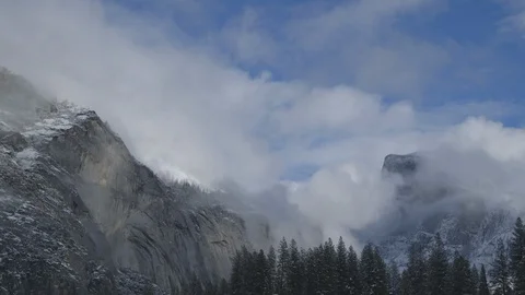 Timelapse of Clouds Moving into Snowy Crags of Yosemite Stock Footage 122400807