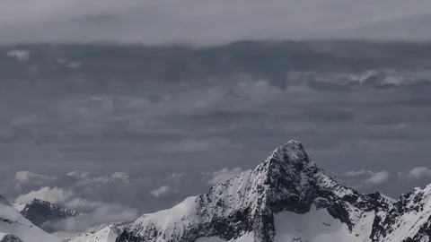 Timelapse with clouds moving with speed over snowy peaks Stock Footage 71756493