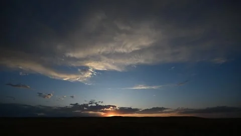 Timelapse of clouds moving at sunset over a flat prairie landscape with colorful Stock Footage 313531849