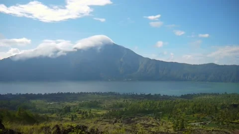 Timelapse of clouds moving from wind in blue sky on sunny day with a volcano Video stock 140212843