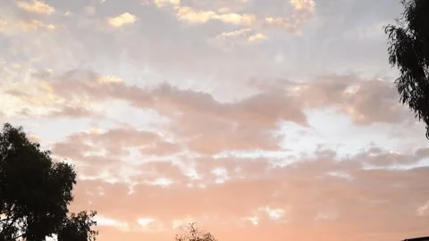 Timelapse of clouds with orange hue sunset Vídeo Stock 266070625