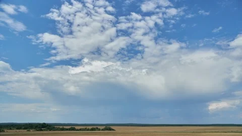 A timelapse of clouds over an agricultural field. A spring landscape Stock Footage 313085061