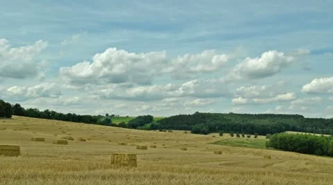 Timelapse - clouds over field with straw bales Stock Footage 11656707
