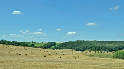 Timelapse - clouds over field with straw bales Stock Footage 23631596