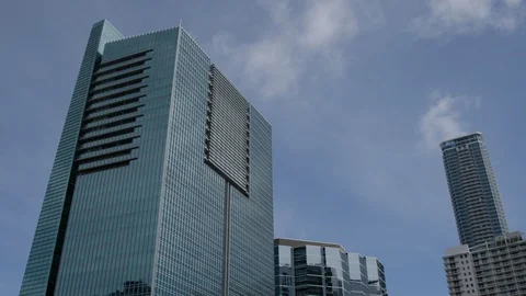 Timelapse of clouds over glass office buildings Stock Footage 124229616