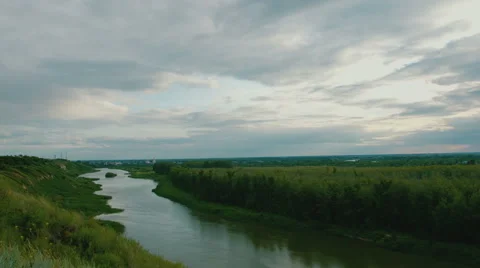 Timelapse clouds over the green field and river Stock Footage 56231347