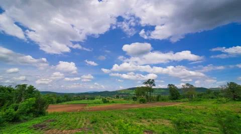 Timelapse clouds over the green field Video stock 64465816