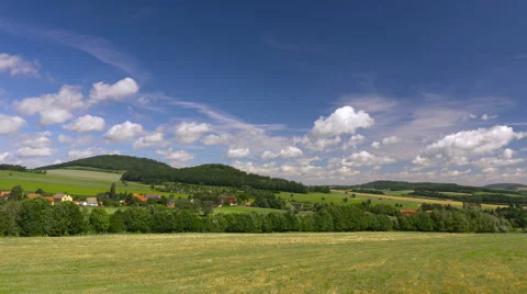 Timelapse clouds over green hills with village. Europe, Germany. Video stock 66530080