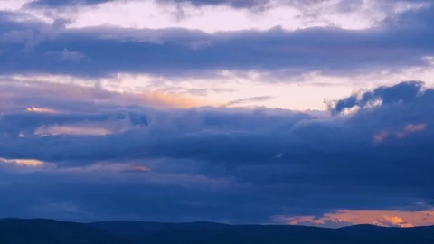 Timelapse of clouds over hills at sunseu Stock Footage 116665927