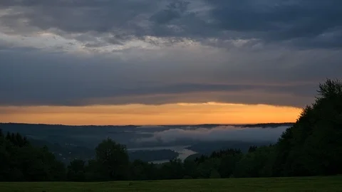 Timelapse of clouds over lake hills forest landscape at dawn Stock Footage 90141683