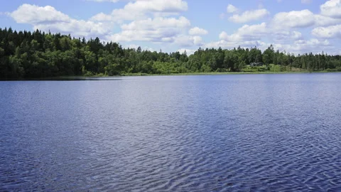 Timelapse of clouds over a lake with trees in summer sweden Stock Footage 156130895