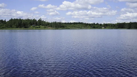 Timelapse of clouds over a lake with trees and reflections in summer sweden Stock Footage 156130896