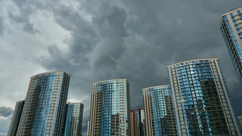A timelapse of clouds over modern skyscrapers. Grey rain clouds Stock Footage 293007805