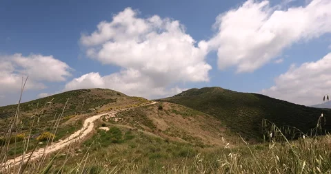 Timelapse of clouds over mountain with dirt road in Southern California .. Video stock 287921105