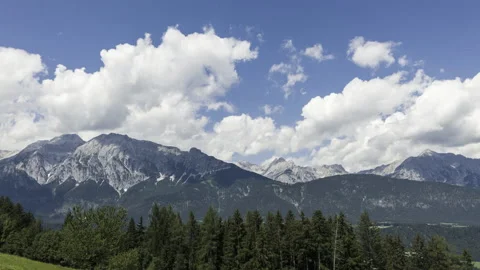 Timelapse of clouds over mountains and trees in foreground summer austria Stock Footage 154949974