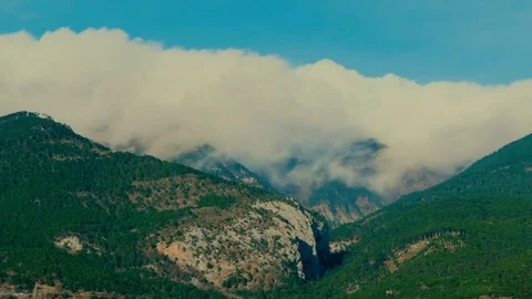 Timelapse of clouds over the mountains. Video stock 83691643