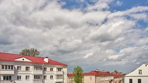 Timelapse of clouds over a multi-storey residential building with a new red roof Stock Footage 293006471