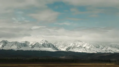 Timelapse of clouds over snow-capped mountain peaks. Stock Footage 312191251