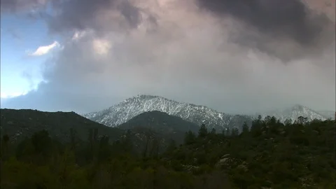 Timelapse clouds over snow covered mountain peak Stock Footage 87845483