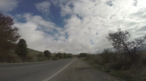 Timelapse of clouds over straight highway Stock Footage 52854822