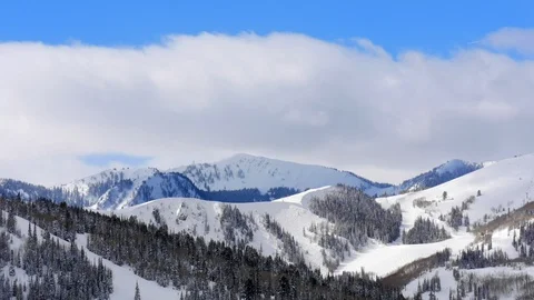 Timelapse of clouds over winter Wasatch Mountains of Deer Valley Resort, Utah. Stock Footage 99257539