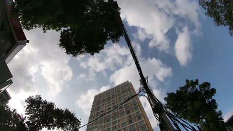 Timelapse with clouds over wires and building 動画素材 163590246