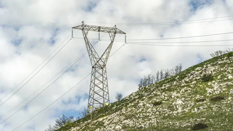 Timelapse of clouds passing behind a high voltage power line pylon Stock Footage 154505725