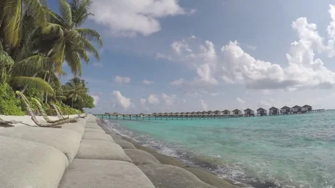 Timelapse of clouds passing by behind palm trees at the maldives Stock Footage 74698019