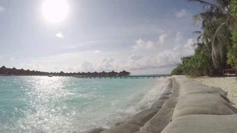 Timelapse of clouds passing by behind palm trees at the maldives Video stock 74698024
