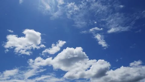 Timelapse of Clouds passing by in the blue sky Stock Footage 134767455
