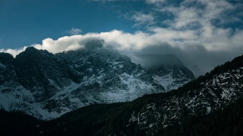 Timelapse of clouds passing a mountain peak Stock Footage 126870102