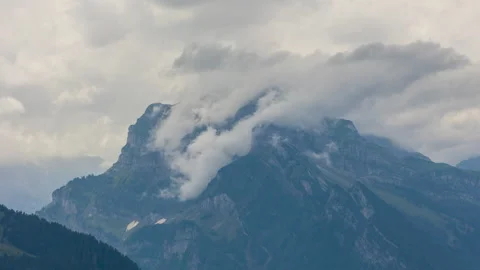 Timelapse of clouds passing mountain peak. Stormy clouds touches mountain pea Video stock 164059777