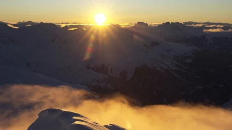 Timelapse of clouds passing by mountain tops at sunrise Stock Footage 102170761