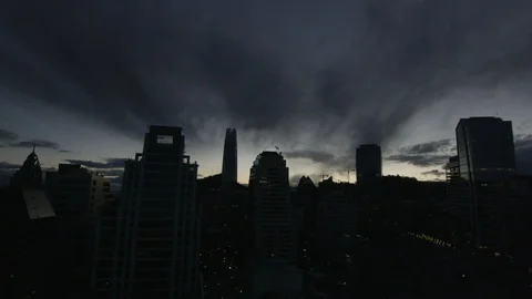 Timelapse of clouds passing over modern city above corporate buildings at night Stock Footage 124239210