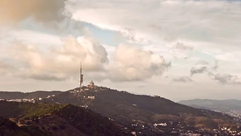Timelapse of clouds passing over mount Tibidabo, in Barcelona, Spain. Stock Footage 69968831