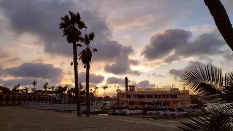 Timelapse of clouds passing over PaddleBoat in pastel skies Stock Footage 100951756